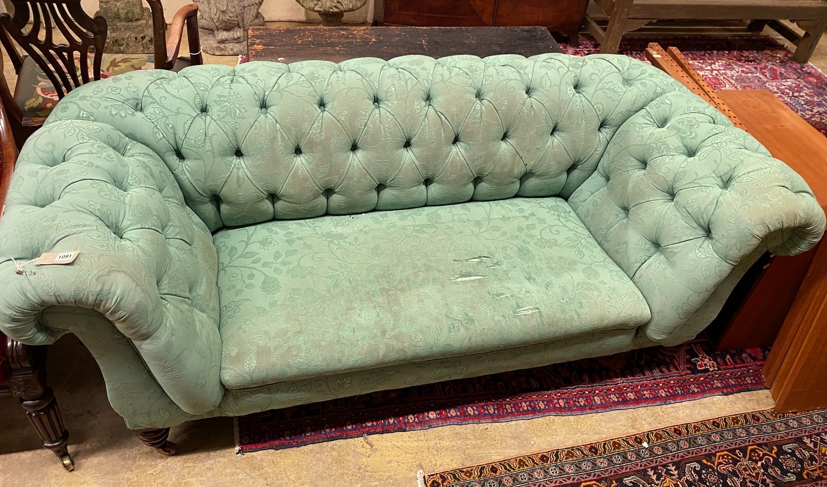 A Victorian double drop arm Chesterfield settee upholstered in a deep buttoned green fabric, length 190cm, width 88cm, height 70cm